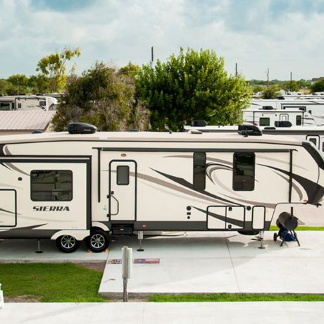 A scenic view of Copano Bay RV Resort in Rockport, TX, featuring multiple recreational vehicles parked in a serene setting.