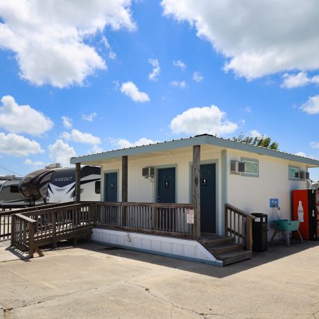 A Cabin and RV parked at Copano Bay RV Resort in Rockport, TX.