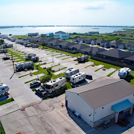 Aerial view of Copano Bay RV Resort in Rockport, TX, showcasing numerous parking spaces in a well-organized RV park.