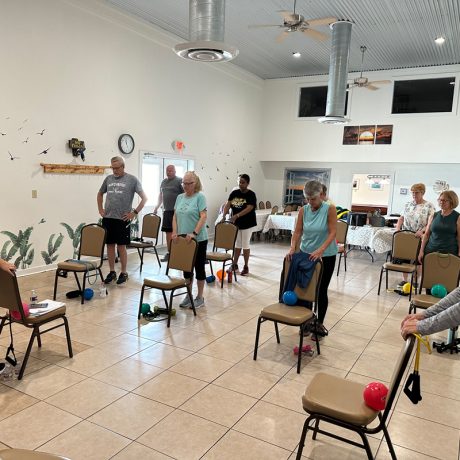 A group of individuals gathered in a room with chairs at Copano Bay RV Resort in Rockport, TX.