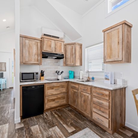 A kitchen featuring wood cabinets and a microwave, located at Copano Bay RV Resort in Rockport, TX.